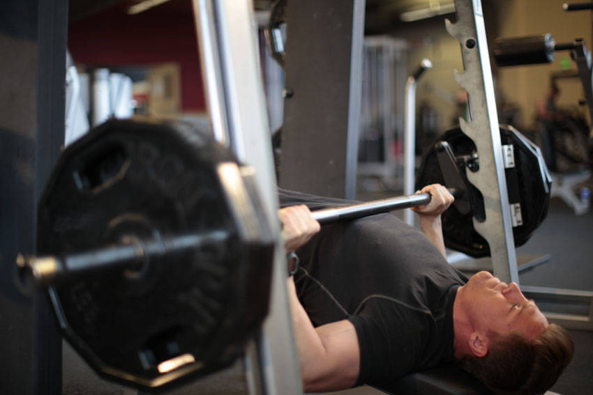 Demonstration of Smith Machine Decline Press exercise showing proper form and technique