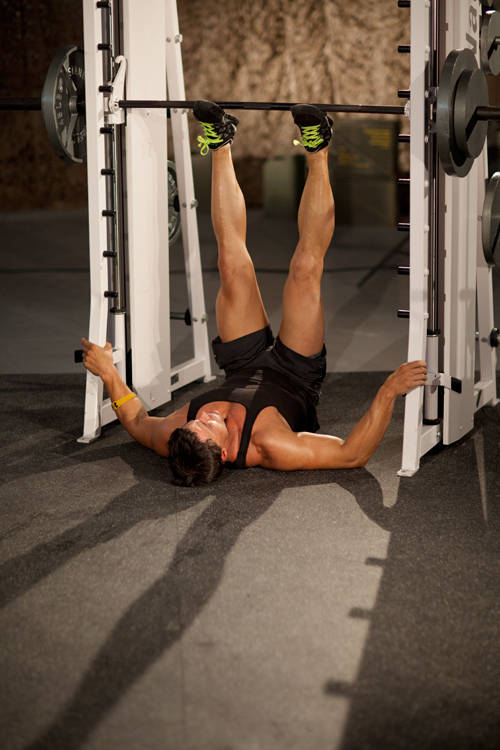 Demonstration of Smith Machine Leg Press exercise showing proper form and technique