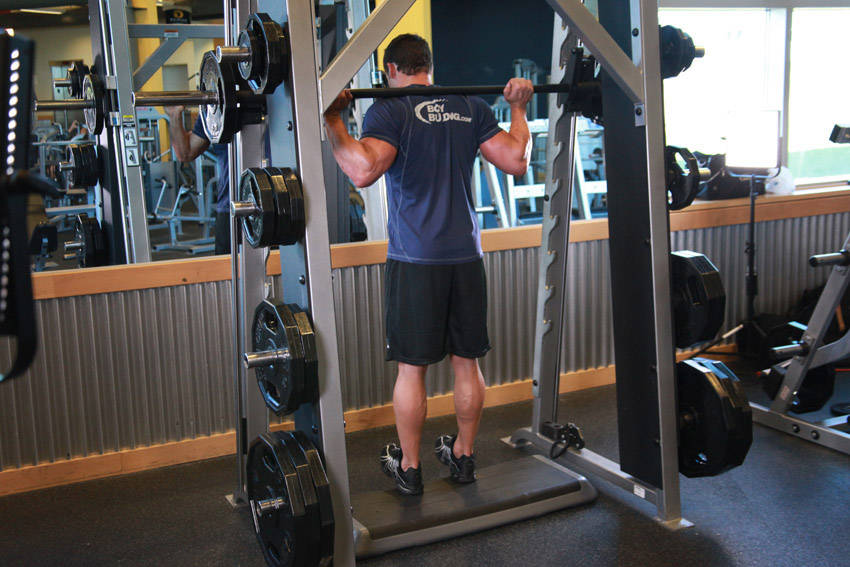 Demonstration of Smith Machine Reverse Calf Raises exercise showing proper form and technique