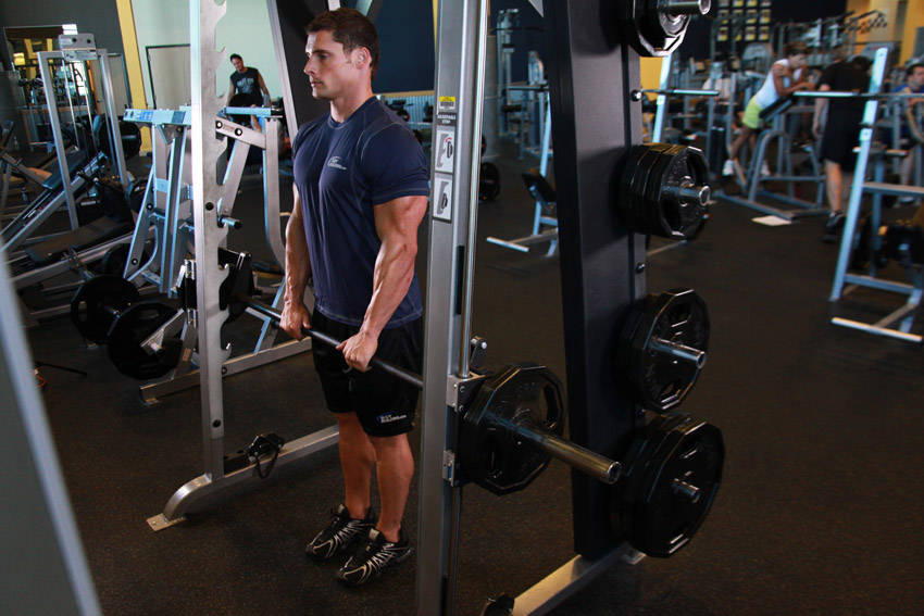 Demonstration of Smith Machine Upright Row exercise showing proper form and technique