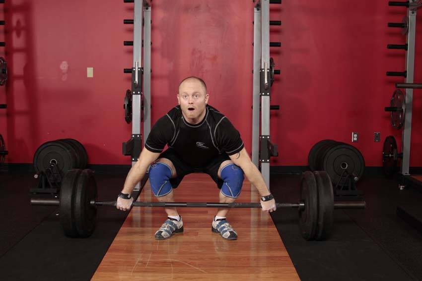 Demonstration of Snatch Pull exercise showing proper form and technique
