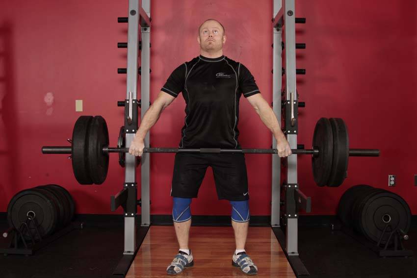Demonstration of Snatch Shrug exercise showing proper form and technique