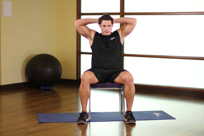Demonstration of Spinal Stretch exercise showing proper form and technique