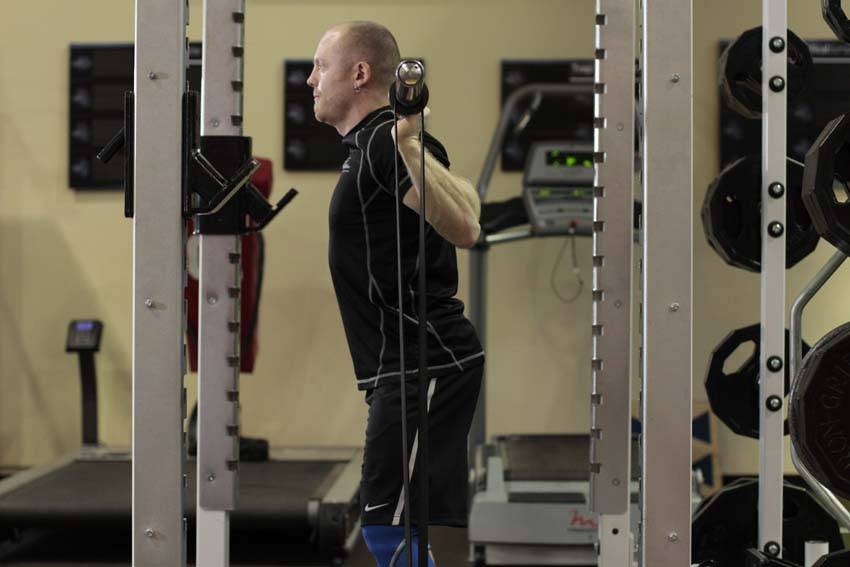 Demonstration of Squat with Bands exercise showing proper form and technique