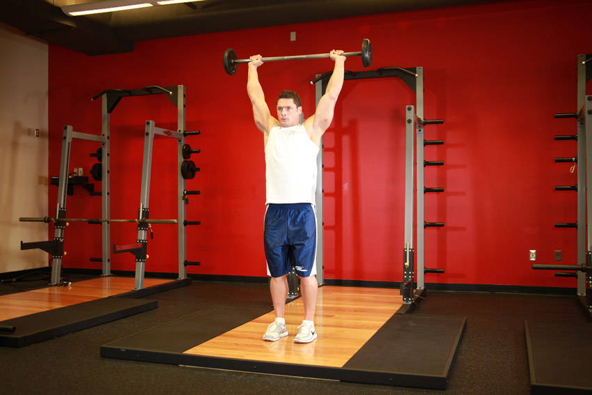 Alternative demonstration of Standing Barbell Press Behind Neck exercise