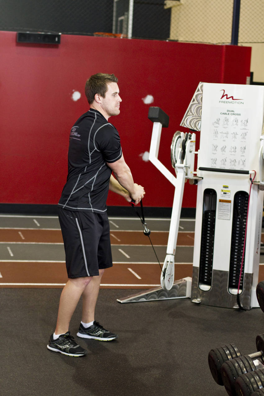 Demonstration of Standing Cable Lift exercise showing proper form and technique