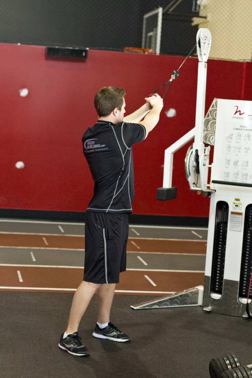 Demonstration of Standing Cable Wood Chop exercise showing proper form and technique