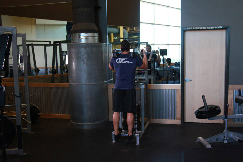 Demonstration of Standing Calf Raises exercise showing proper form and technique