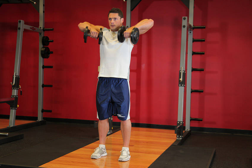 Demonstration of Standing Dumbbell Upright Row exercise showing proper form and technique