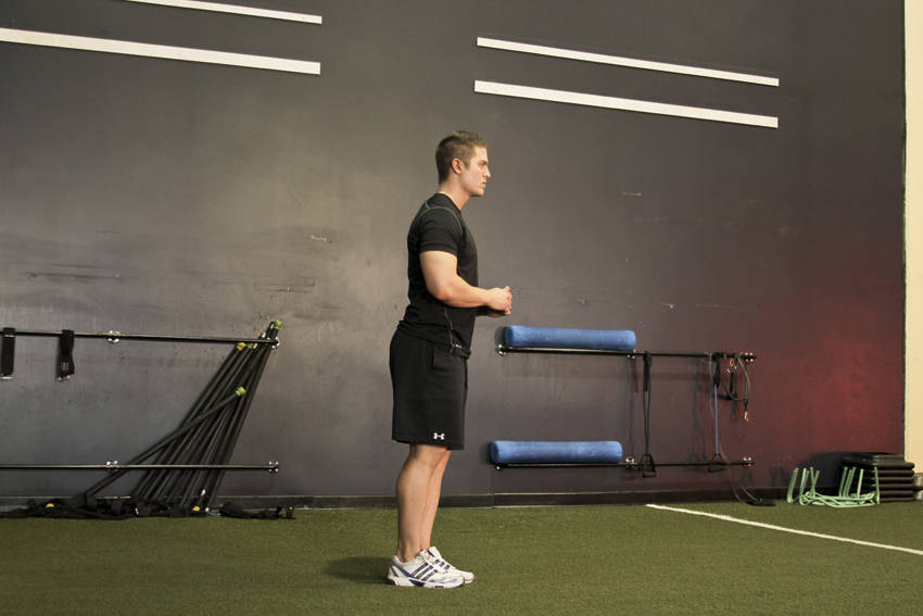 Demonstration of Standing Hip Circles exercise showing proper form and technique