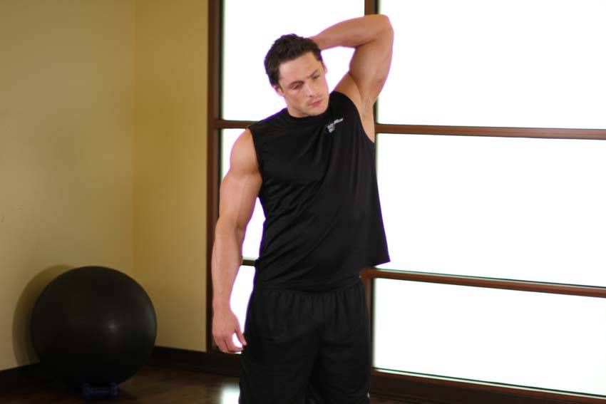 Demonstration of Standing Lateral Stretch exercise showing proper form and technique