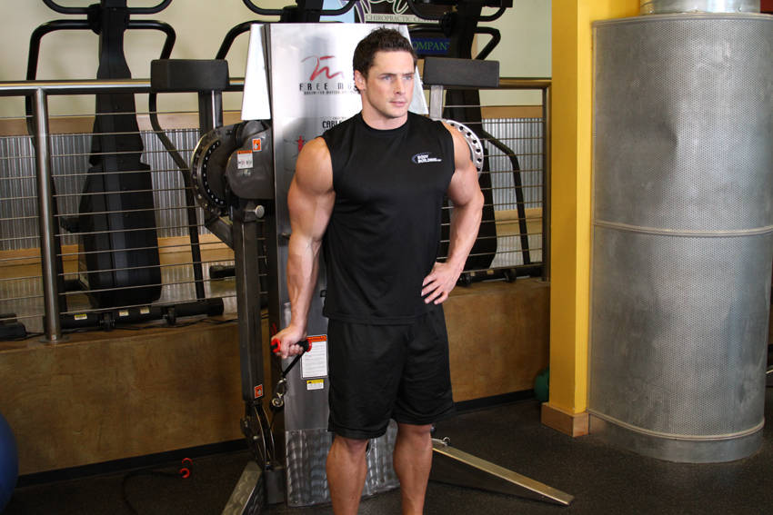 Demonstration of Standing One-Arm Cable Curl exercise showing proper form and technique