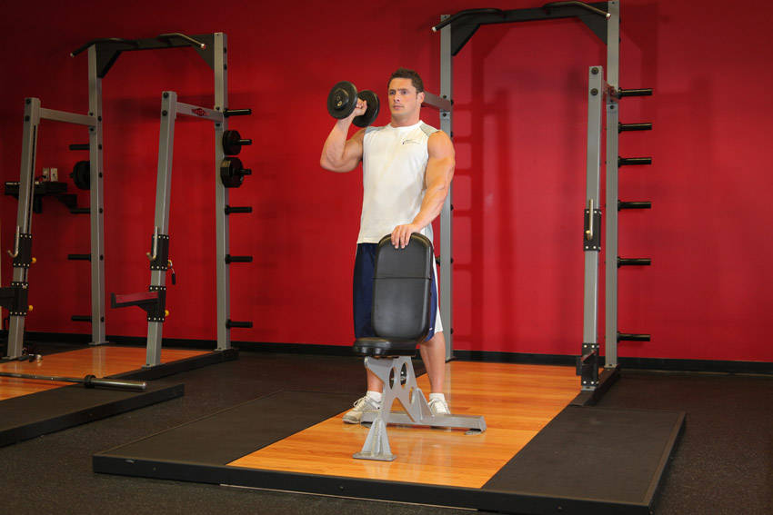 Demonstration of Standing Palm-In One-Arm Dumbbell Press exercise showing proper form and technique