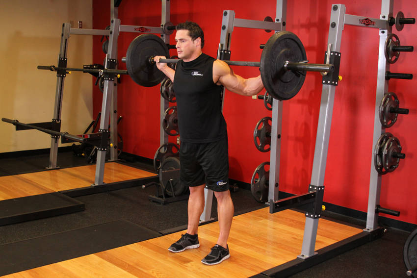 Demonstration of Stiff Leg Barbell Good Morning exercise showing proper form and technique