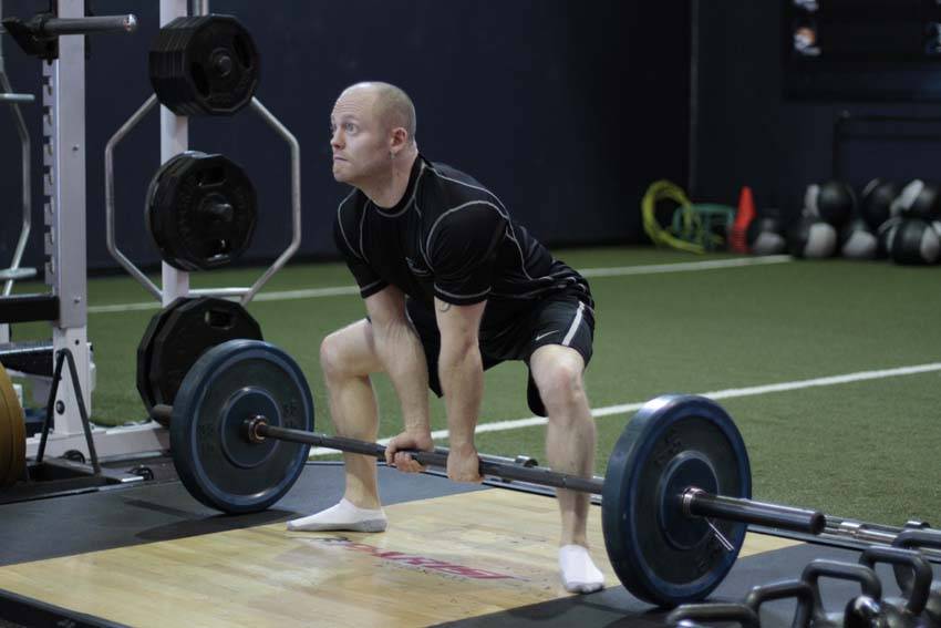 Demonstration of Sumo Deadlift exercise showing proper form and technique