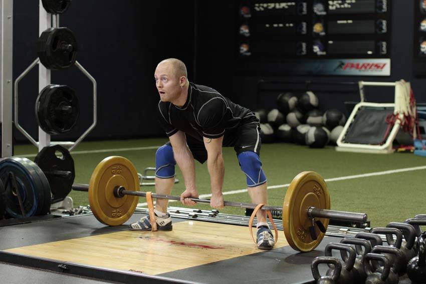 Demonstration of Sumo Deadlift with Bands exercise showing proper form and technique