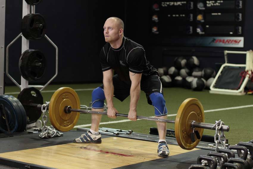 Demonstration of Sumo Deadlift with Chains exercise showing proper form and technique