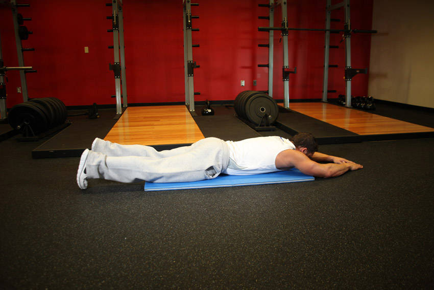 Demonstration of Superman exercise showing proper form and technique