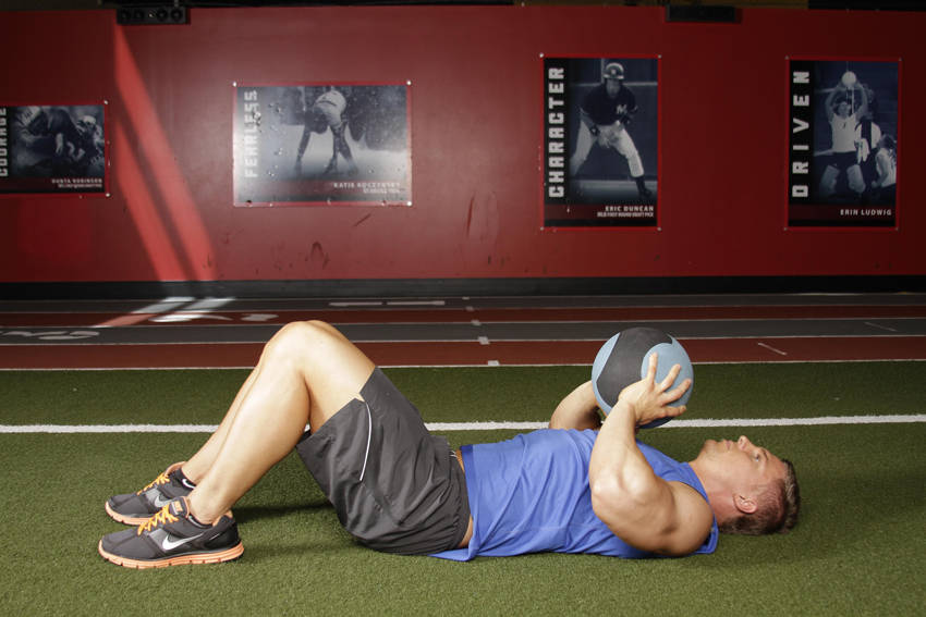 Demonstration of Supine Chest Throw exercise showing proper form and technique