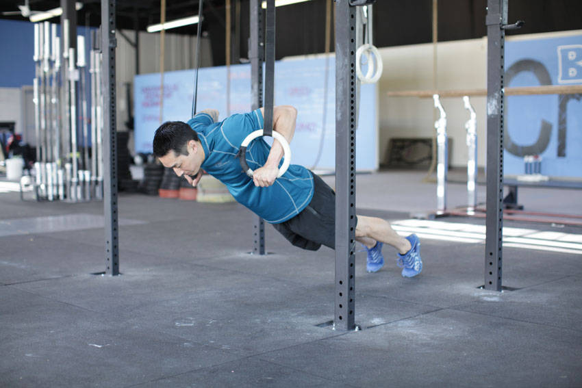 Demonstration of Suspended Push-Up exercise showing proper form and technique