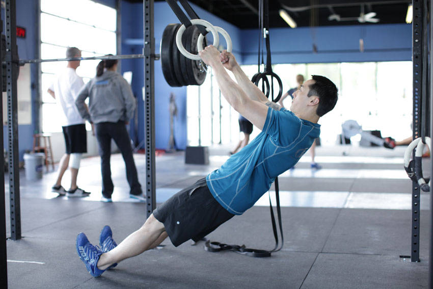 Demonstration of Suspended Row exercise showing proper form and technique