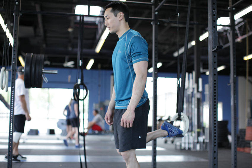 Demonstration of Suspended Split Squat exercise showing proper form and technique