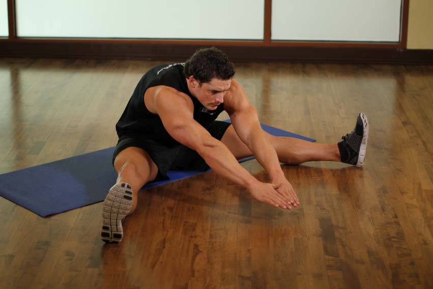 Demonstration of The Straddle exercise showing proper form and technique