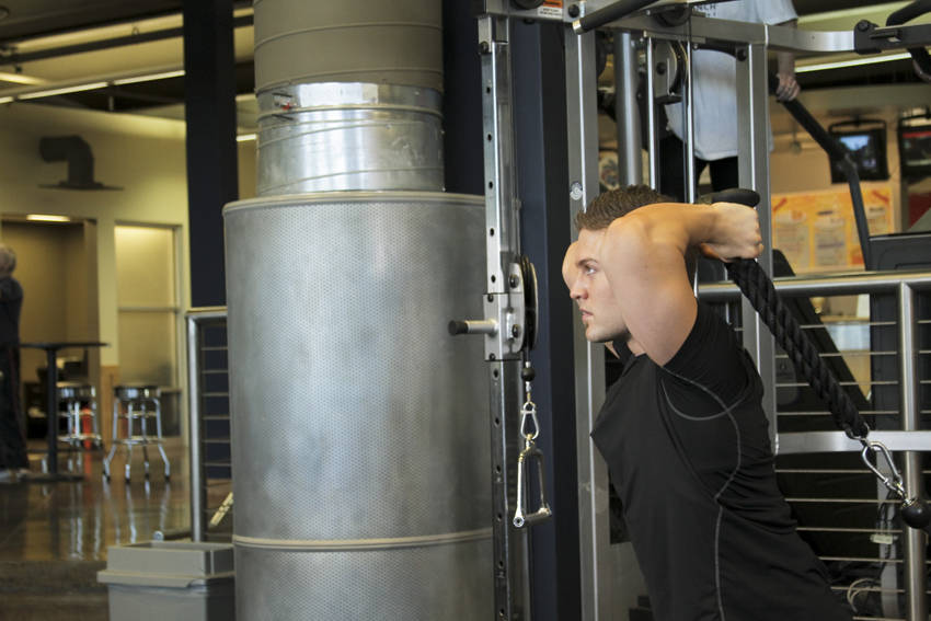 Demonstration of Triceps Overhead Extension with Rope exercise showing proper form and technique