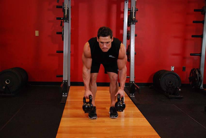 Demonstration of Two-Arm Kettlebell Row exercise showing proper form and technique