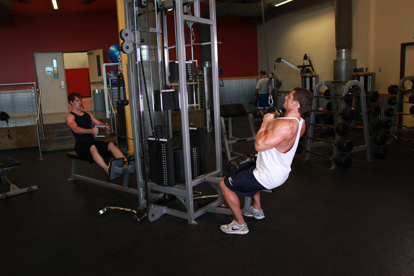 Demonstration of V-Bar Pulldown exercise showing proper form and technique