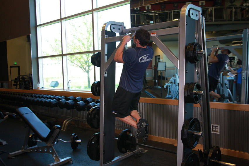 Demonstration of V-Bar Pullup exercise showing proper form and technique