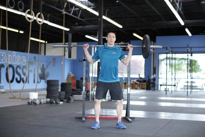 Demonstration of Weighted Jump Squat exercise showing proper form and technique
