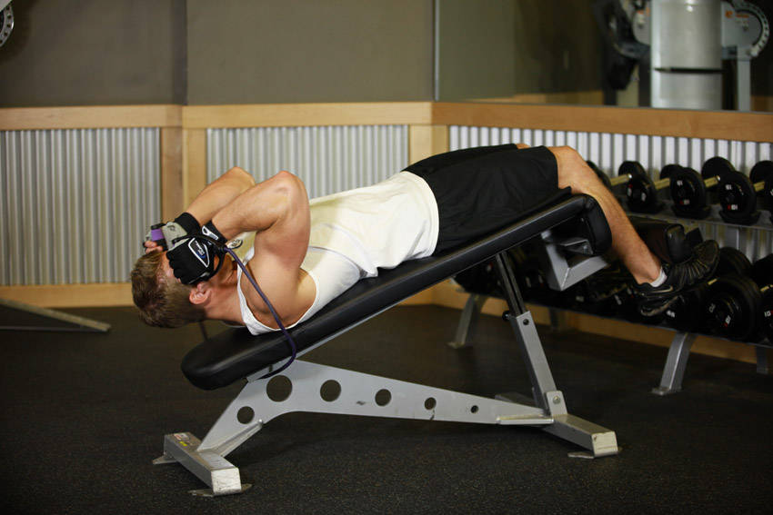 Demonstration of Weighted Sit-Ups - With Bands exercise showing proper form and technique