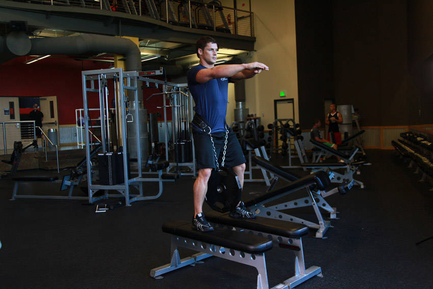 Demonstration of Weighted Squat exercise showing proper form and technique