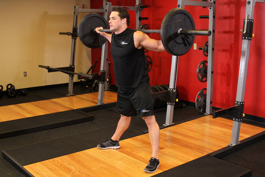 Demonstration of Wide Stance Barbell Squat exercise showing proper form and technique