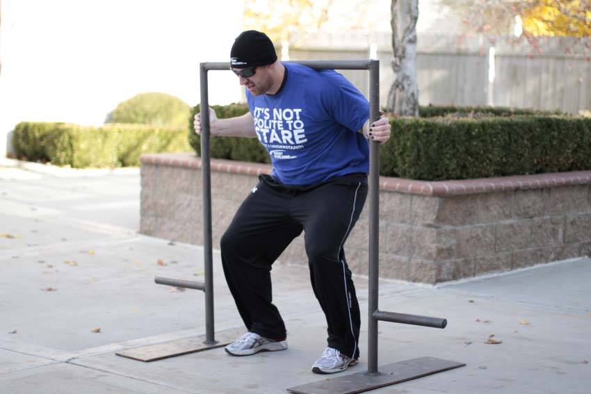 Demonstration of Yoke Walk exercise showing proper form and technique